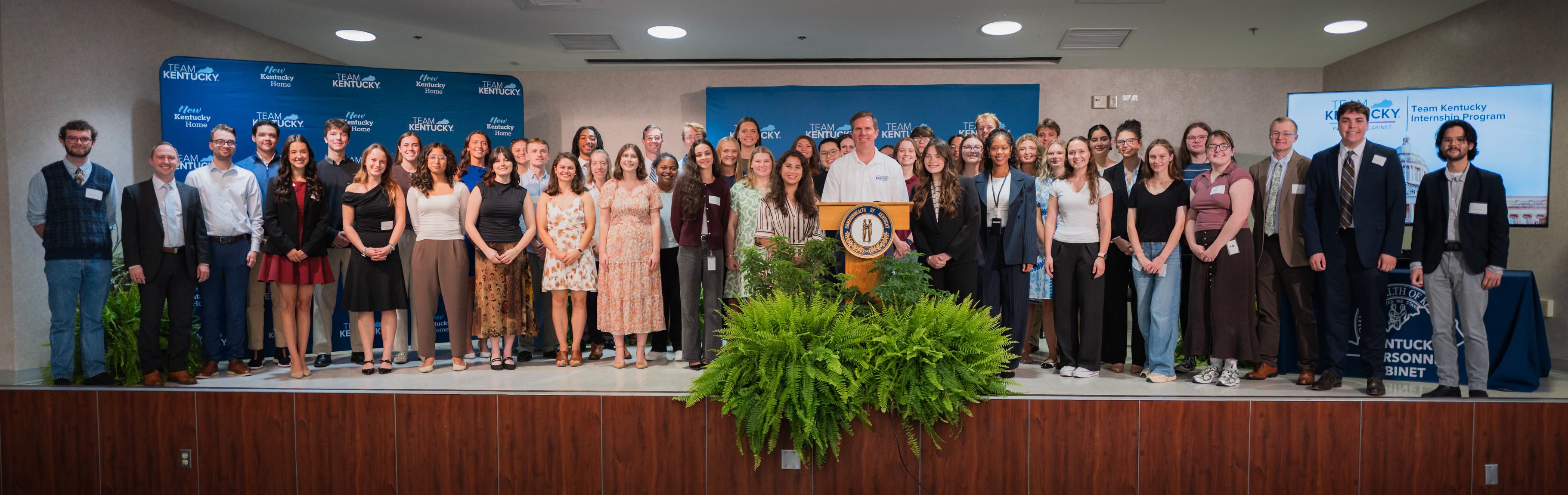 TKIP interns posing for a picture on stage with Gov. Beshear